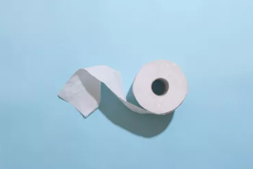 white toilet paper roll on white table